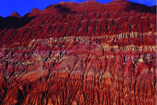 新疆火焰山是吐鲁番最出名的景点，位于吐鲁番盆地的北缘，古丝绸之路北道。火焰山以红色的砂岩反射阳光而闻名遐迩，这座火焰山又称“红山”。 